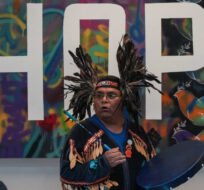 Members of the Musqueam First Nation perform a welcome dance before Musqueam Coast Salish artists and siblings Chrystal Sparrow and Chris Sparrow unveil a spindle whorl carving they created as a gift to the school from the 2019 graduating class, at Magee Secondary School in Vancouver, on Friday, September 23, 2022. The carving was unveiled ahead of Truth and Reconciliation Week and Orange Shirt Day as part of an art and film project in collaboration with the Musqueam First Nation, the school and local businesses. Darryl Dyck/The Canadian Press. 