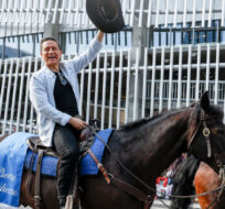 Conservative Party leader Pierre Poilievre, centre, rides a horse with his wife Anaida Poilievre during the Calgary Stampede parade in Calgary, Friday, July 7, 2023. Jeff McIntosh/The Canadian Press. 