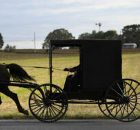 Bishop Marvin and his wife, Stella, steer their horse-drawn buggy toward church
on May 17, 2020, in New Holland, Pa. Jessie Wardarski/AP Photo.