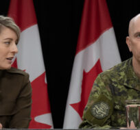 Minister of Foreign Affairs Melanie Joly speaks with Chief of the Defence Staff Wayne Eyre during a news conference on Oct. 11, 2023. Adrian Wyld/The Canadian Press.