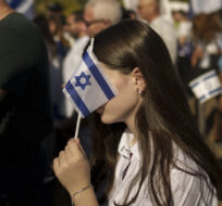 People hold Israeli flags during a rally in support of Israel in Bucharest, Romania on Oct. 12, 2023. Vadim Ghirda/AP Photo.