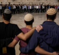 People attend a ceremony to mark the one-month anniversary of the bloody Oct. 7 cross-border attack by Hamas militants, in front of the Western Wall, the holiest site where Jews can pray, in Jerusalem's Old City, Tuesday, Nov. 7, 2023. Leo Correa/AP Photo. 
