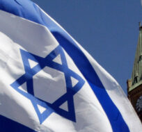 The Israeli flag flies with the Peace Tower in the background in Ottawa Sunday, April 21, 2002. Jonathan Hayward/CP Photo. 