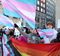 People protest Alberta Premier Danielle Smith's proposed youth transgender policies as she appears at an event in Ottawa on Monday, Feb. 5, 2024. Patrick Doyle/The Canadian Press